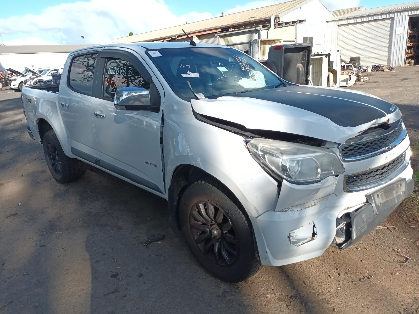 A Silver Truck With a Black Hood is Parked in a Parking Lot — South West 4WD Wreckers In Harristown, QLD
