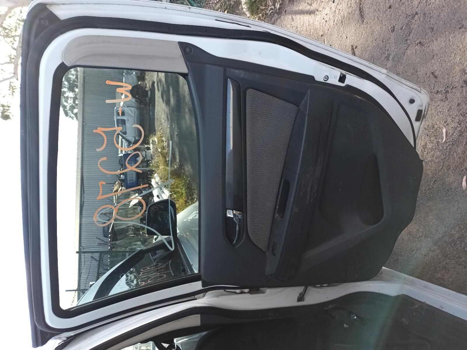 The Back Door of a White Car is Open and Has a Sticker on It — South West 4WD Wreckers In Harristown, QLD