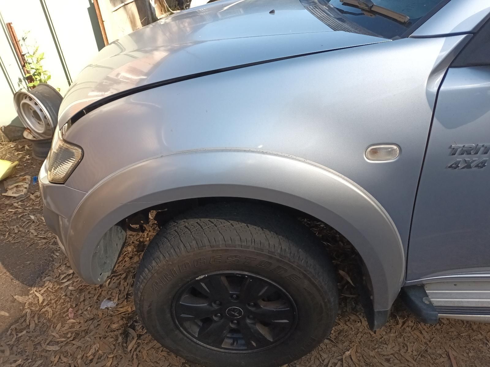 A Silver Truck with the Hood Down is Sitting on the Ground — South West 4WD Wreckers in Harristown, QLD