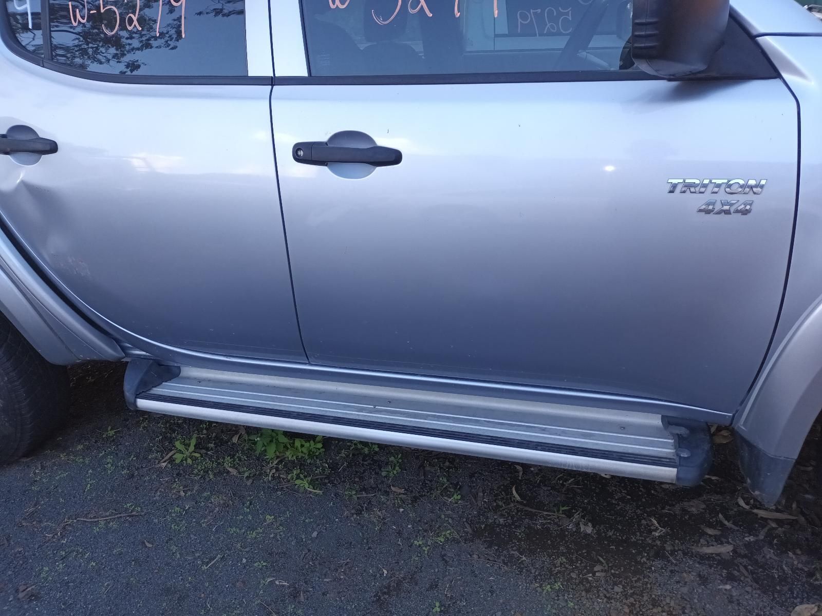 A Silver Truck is Parked on the Side of the Road — South West 4WD Wreckers in Harristown, QLD