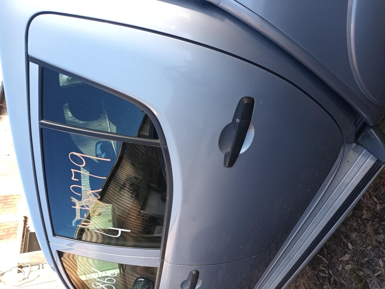A Close Up of a Car Door with a Reflection of a Person in the Window — South West 4WD Wreckers in Harristown, QLD