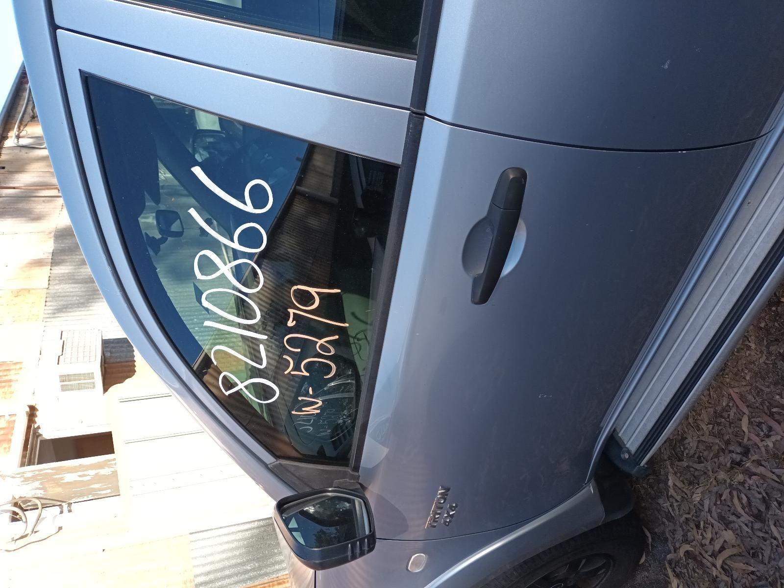 A Silver Car with a Numbers on the Window — South West 4WD Wreckers in Harristown, QLD