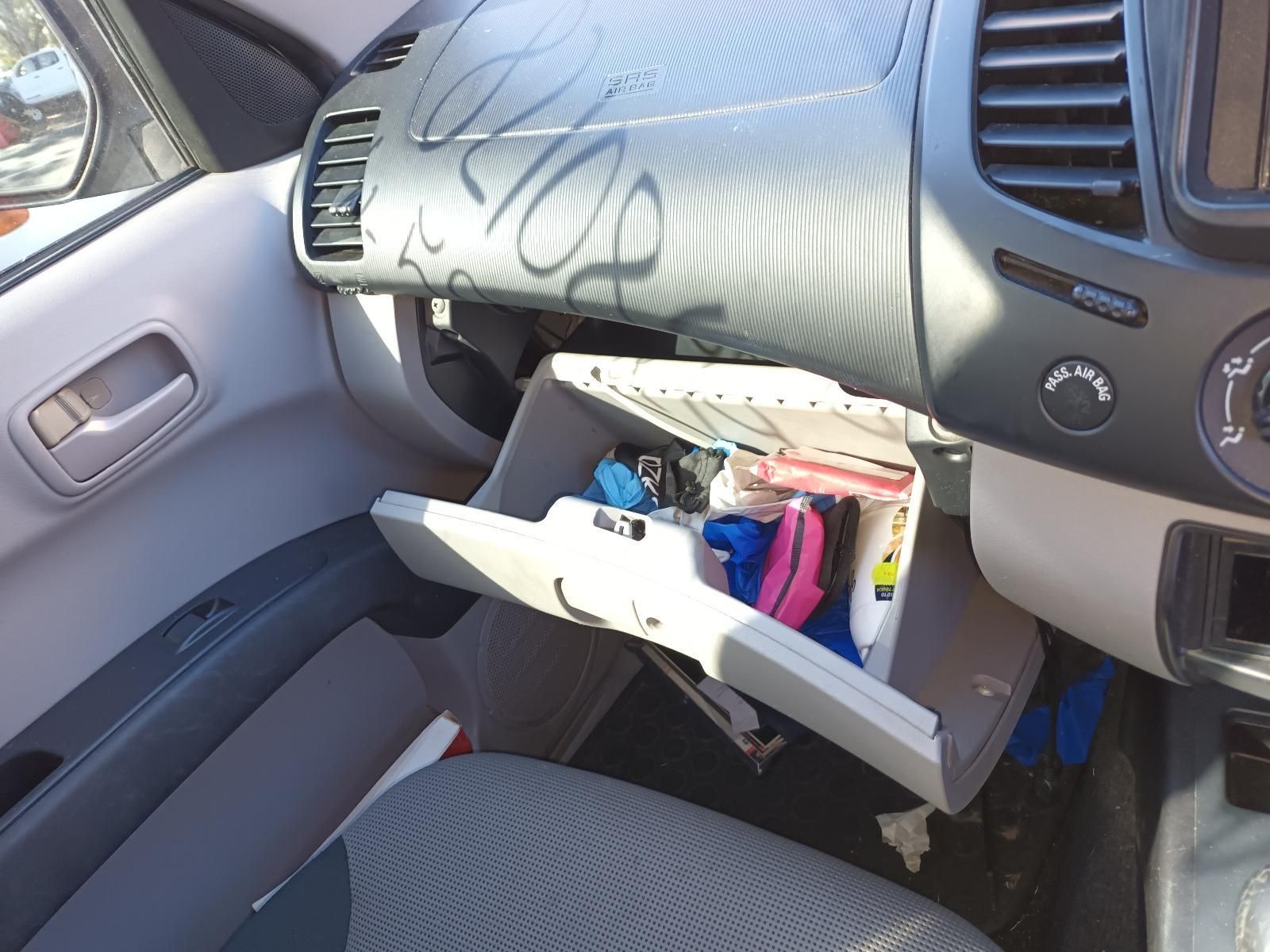 The Glove Box of a Car is Open and Filled with Various Items — South West 4WD Wreckers in Harristown, QLD