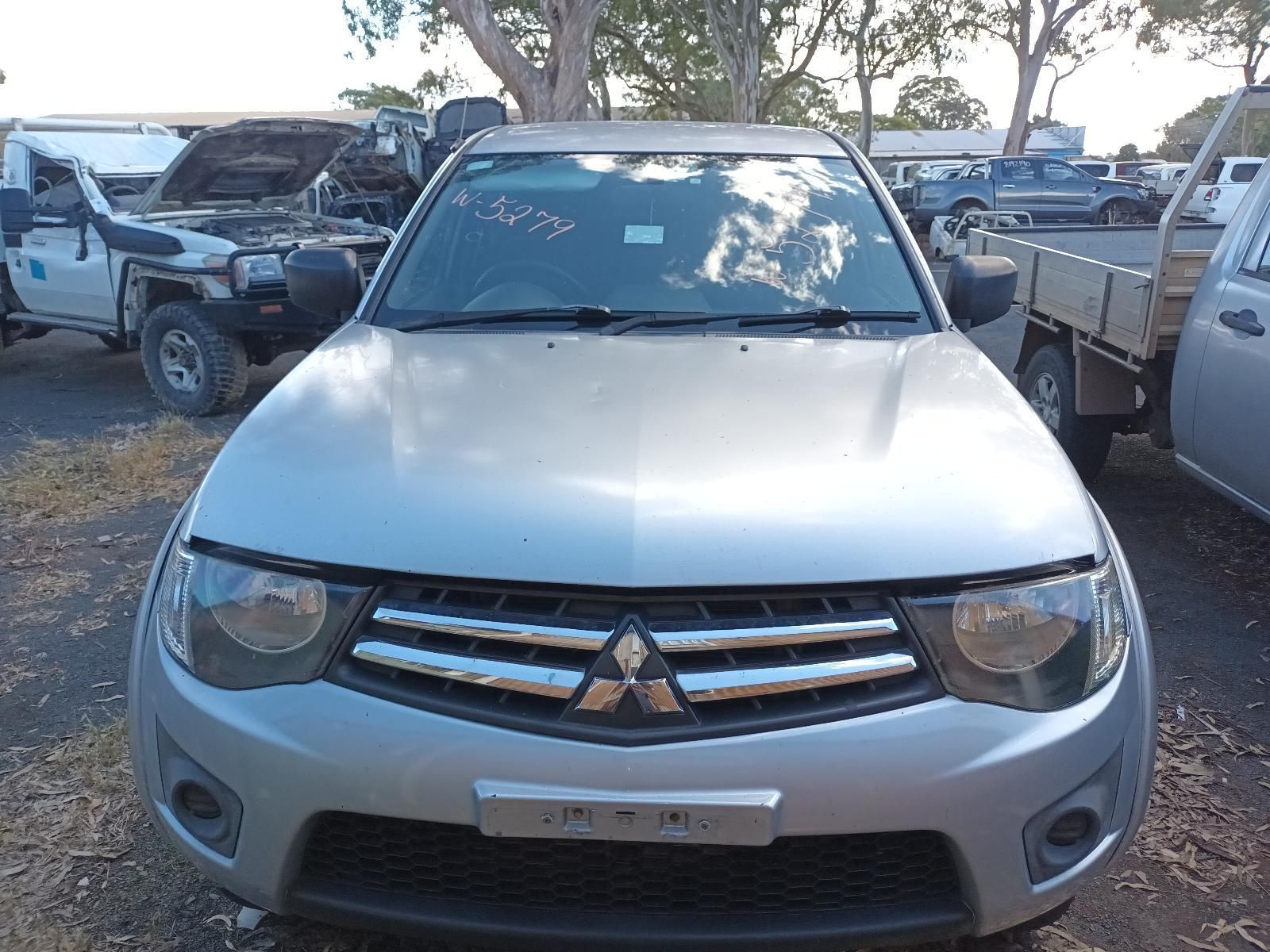 A Silver Mitsubishi Triton is Parked in a Lot — South West 4WD Wreckers in Harristown, QLD