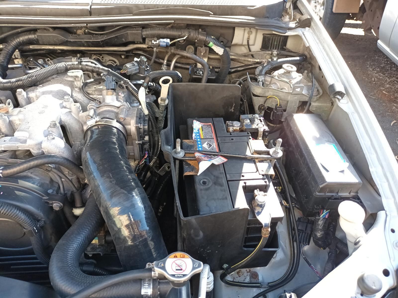 The Engine of a Car is Shown with the Battery Removed — South West 4WD Wreckers in Harristown, QLD