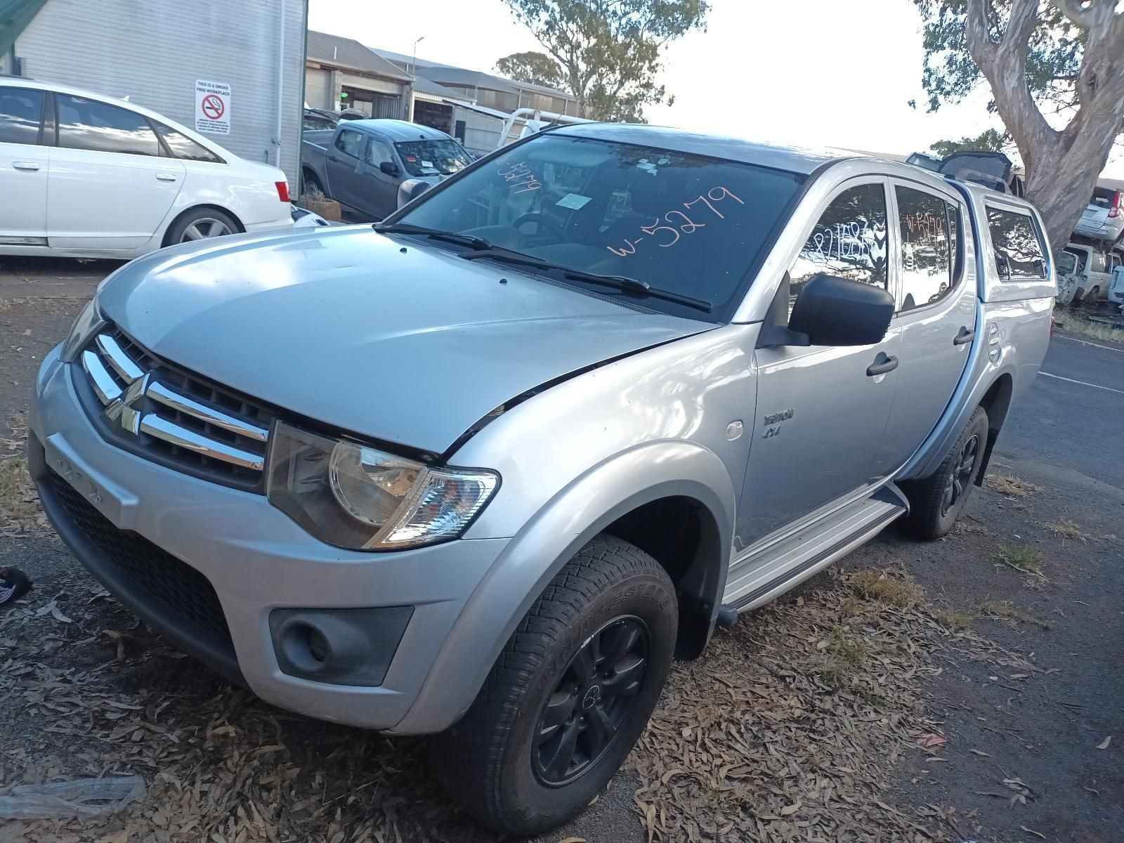 A Silver Truck is Parked on the Side of the Road — South West 4WD Wreckers in Harristown, QLD