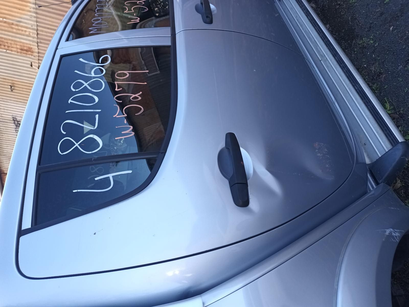 A Silver Car with the Numbers Written on the Window — South West 4WD Wreckers in Harristown, QLD