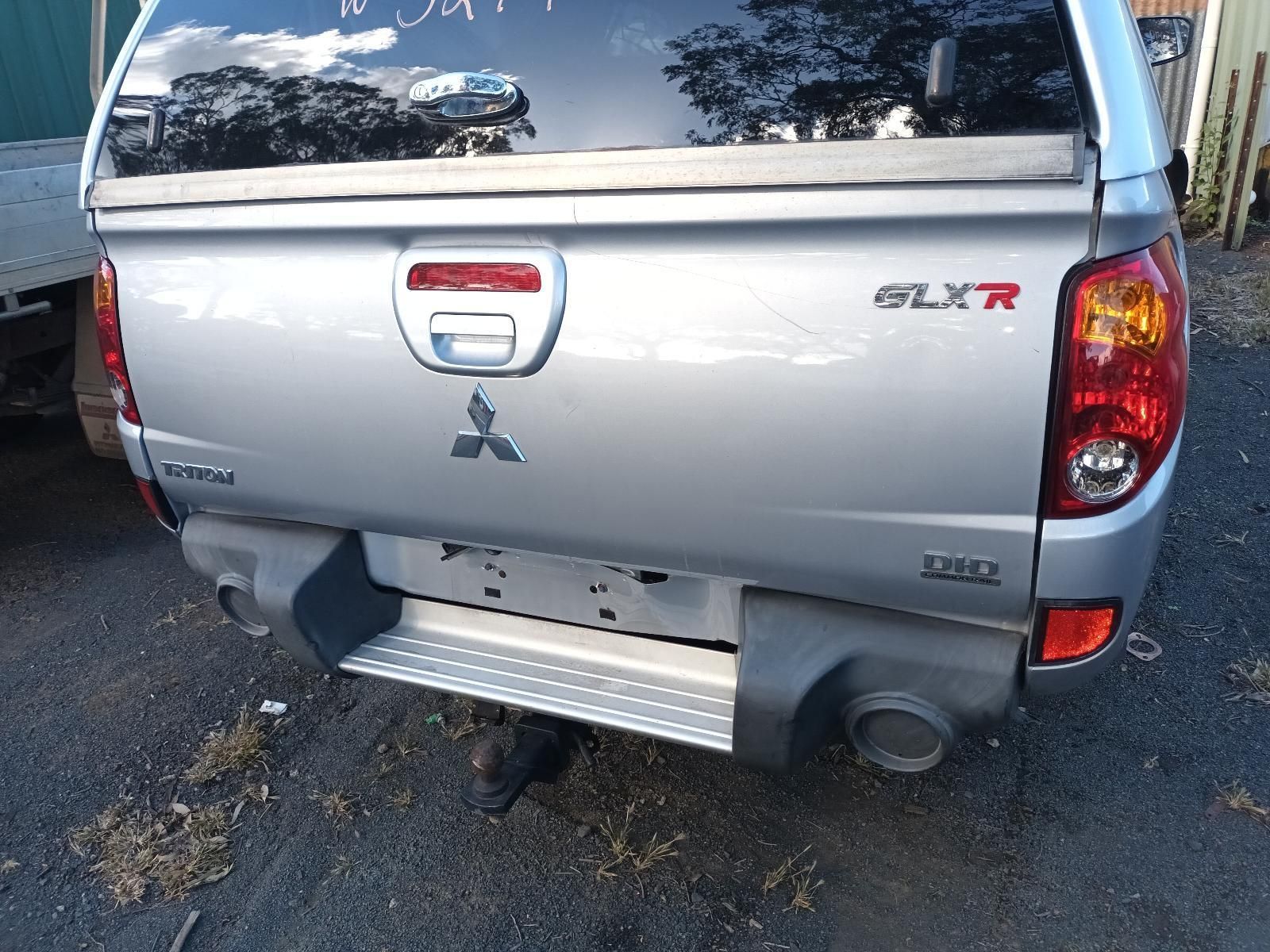A Silver Mitsubishi Truck is Parked on the Side of the Road — South West 4WD Wreckers in Harristown, QLD