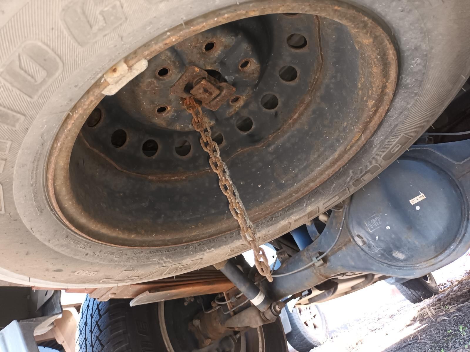 A Close Up of a Tire on a Truck with a Chain Attached to It — South West 4WD Wreckers in Harristown, QLD