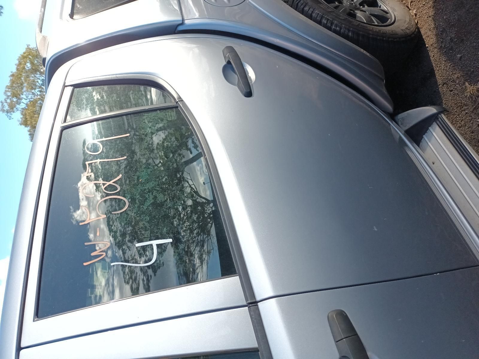 A Silver Truck is Parked on the Side of the Road — South West 4WD Wreckers in Harristown, QLD