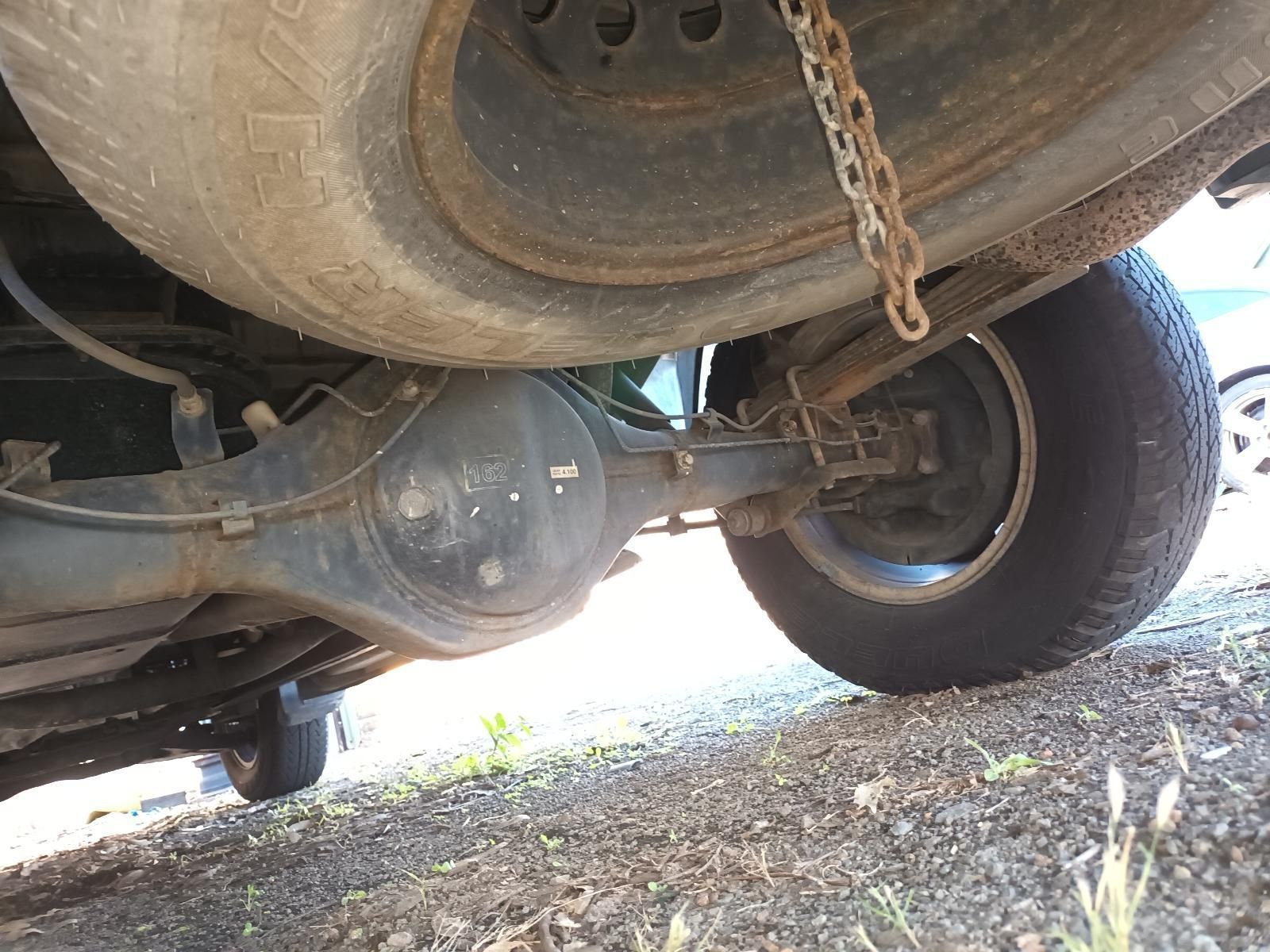 A Close Up of the Underside of a Car with a Chain Attached to It — South West 4WD Wreckers in Harristown, QLD