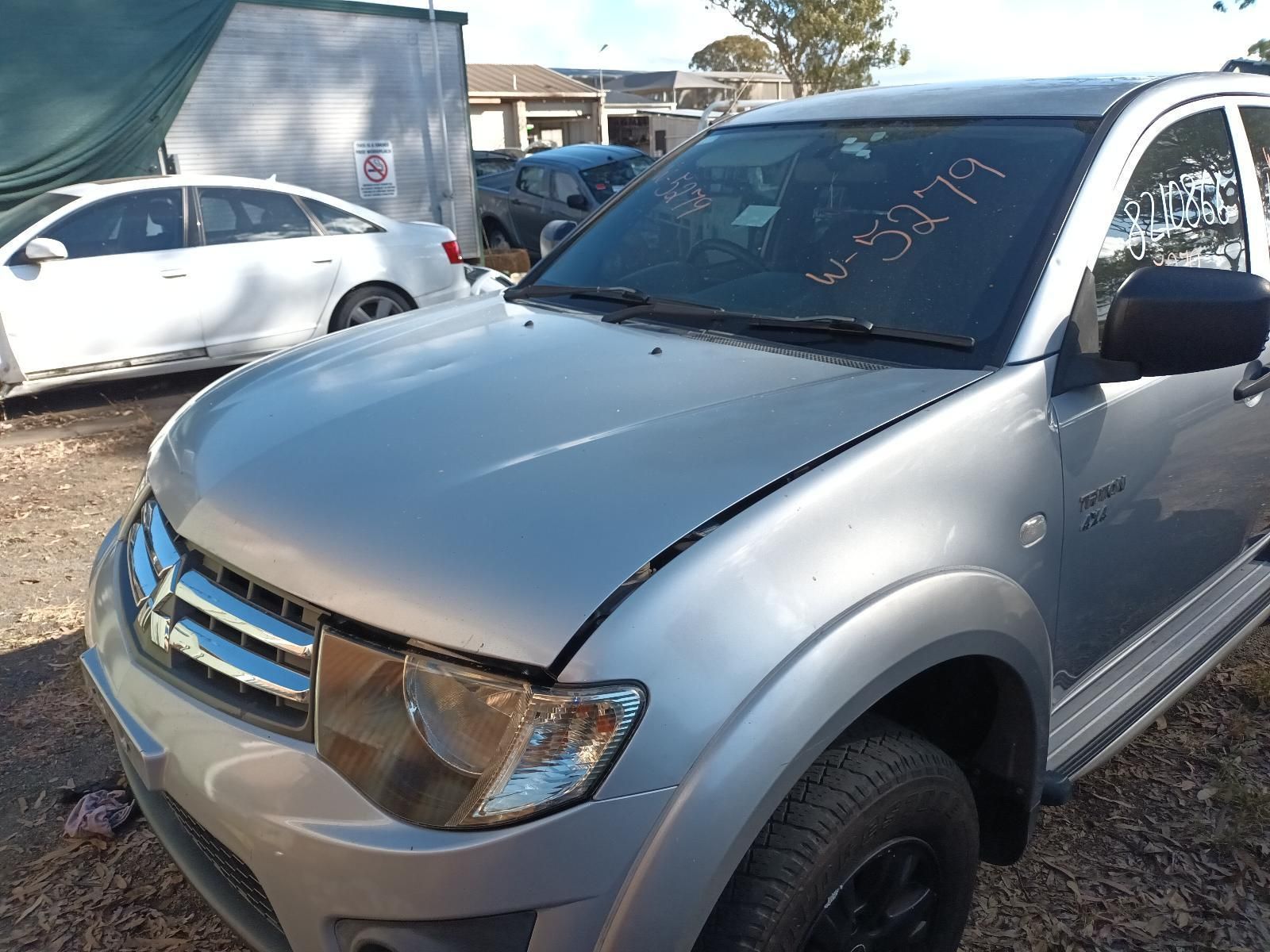 A Silver Truck is Parked in a Gravel Lot — South West 4WD Wreckers in Harristown, QLD 