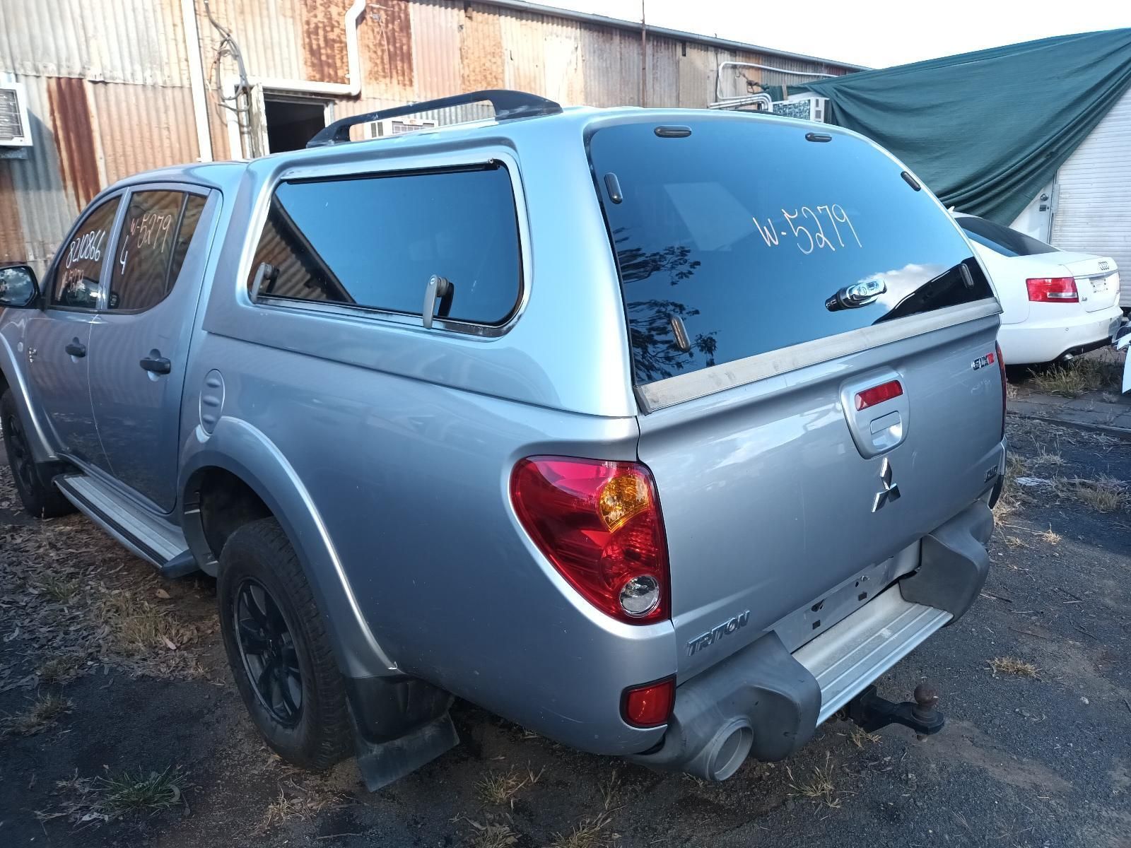 A Silver Truck with a Canopy is Parked in a Parking Lot — South West 4WD Wreckers in Harristown, QLD