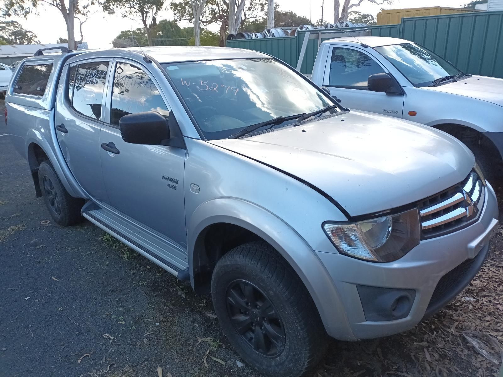 A Silver Truck is Parked on the Side of the Road — South West 4WD Wreckers in Harristown, QLD