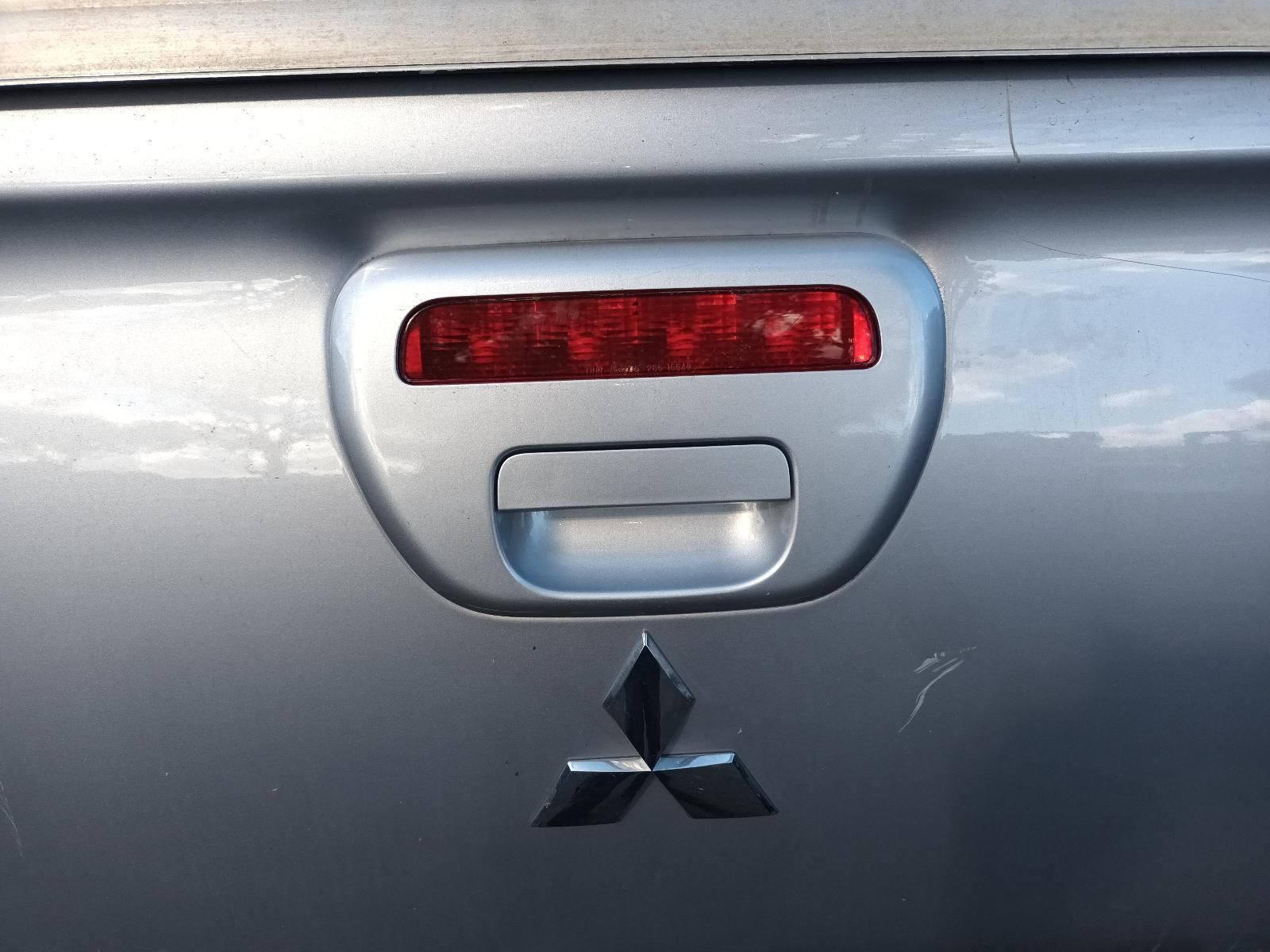 A Silver Mitsubishi Truck with a Red Tail Light — South West 4WD Wreckers in Harristown, QLD