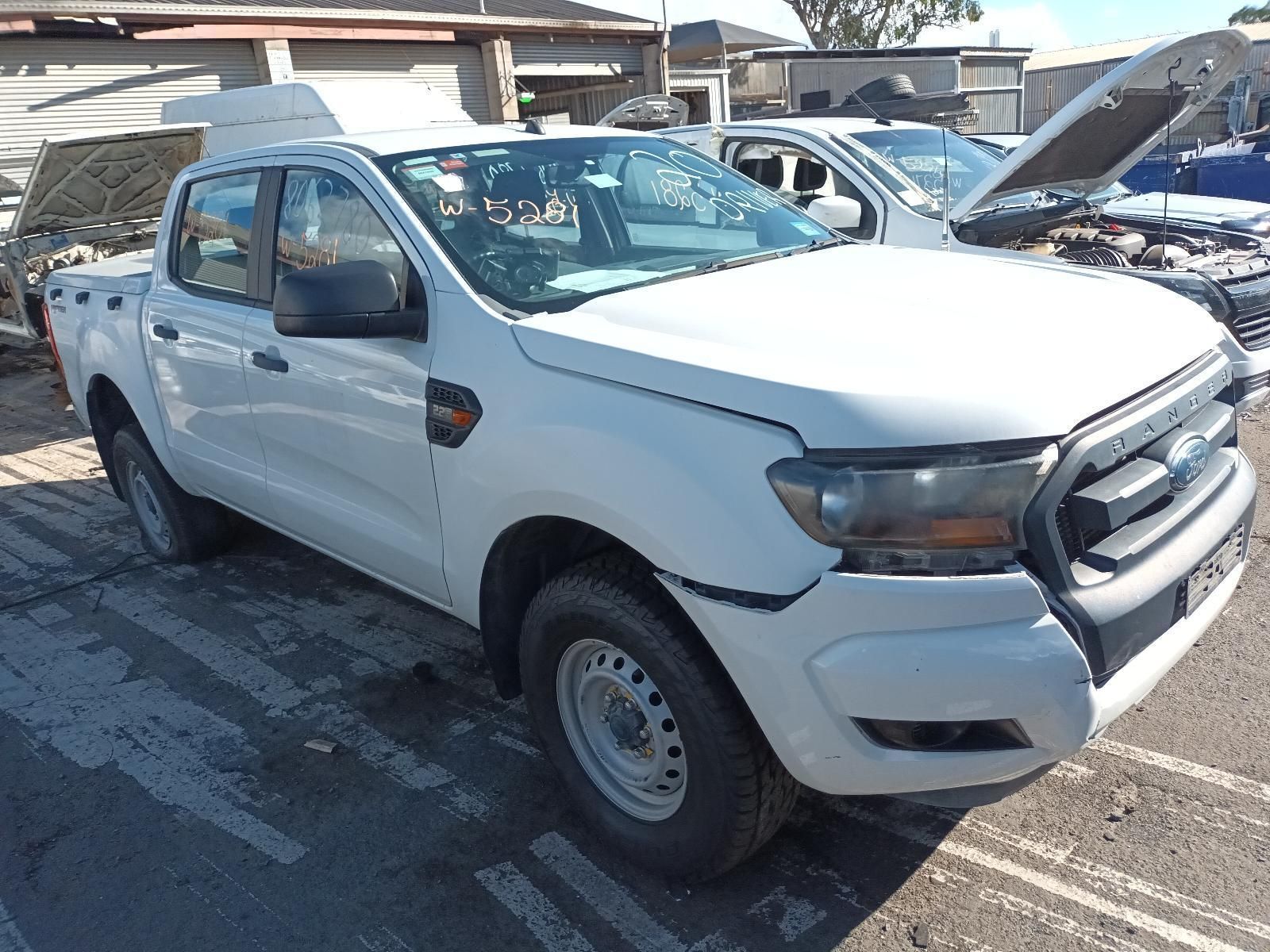 A White Truck with the Hood Up is Parked in a Parking Lot — South West 4WD Wreckers in Harristown, QLD