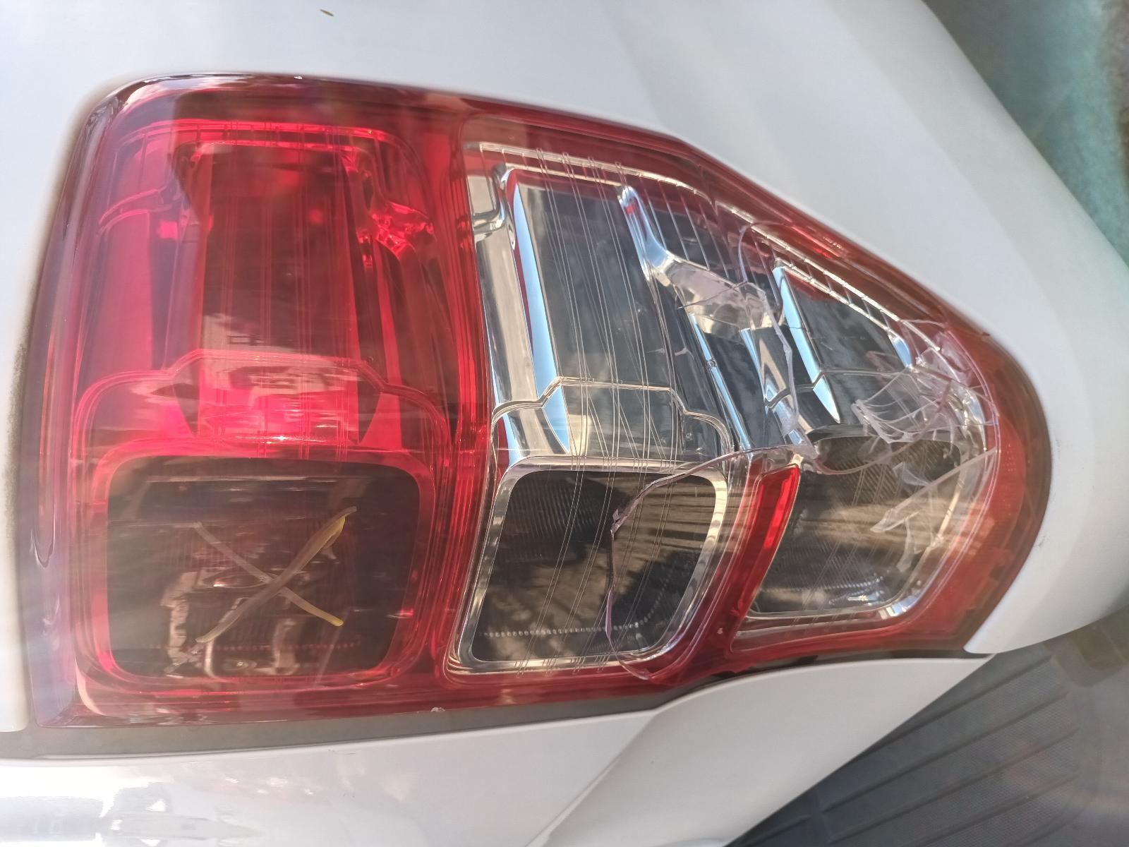 A Close Up of a Broken Tail Light on a White Car — South West 4WD Wreckers in Harristown, QLD