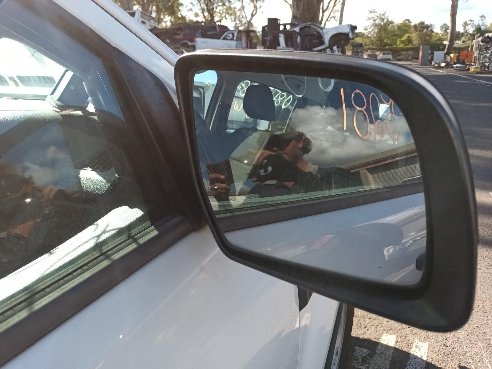 A Side View Mirror on a White Car — South West 4WD Wreckers in Harristown, QLD