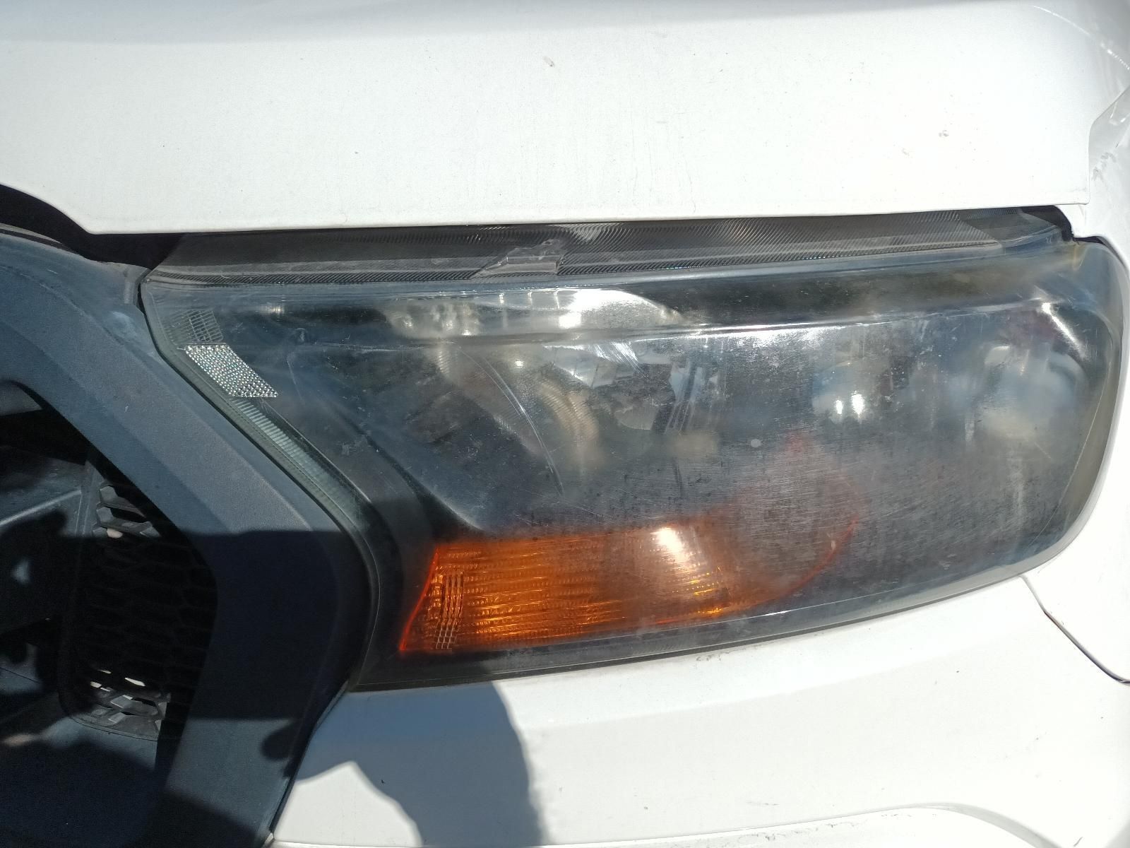 A Close Up of a White Car's Headlight — South West 4WD Wreckers in Harristown, QLD