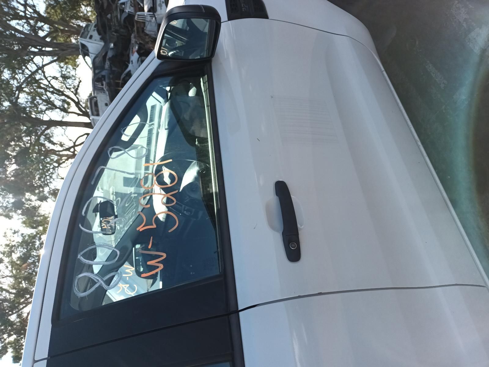 A White Car with a Black Door Handle is Parked on the Side of the Road — South West 4WD Wreckers in Harristown, QLD