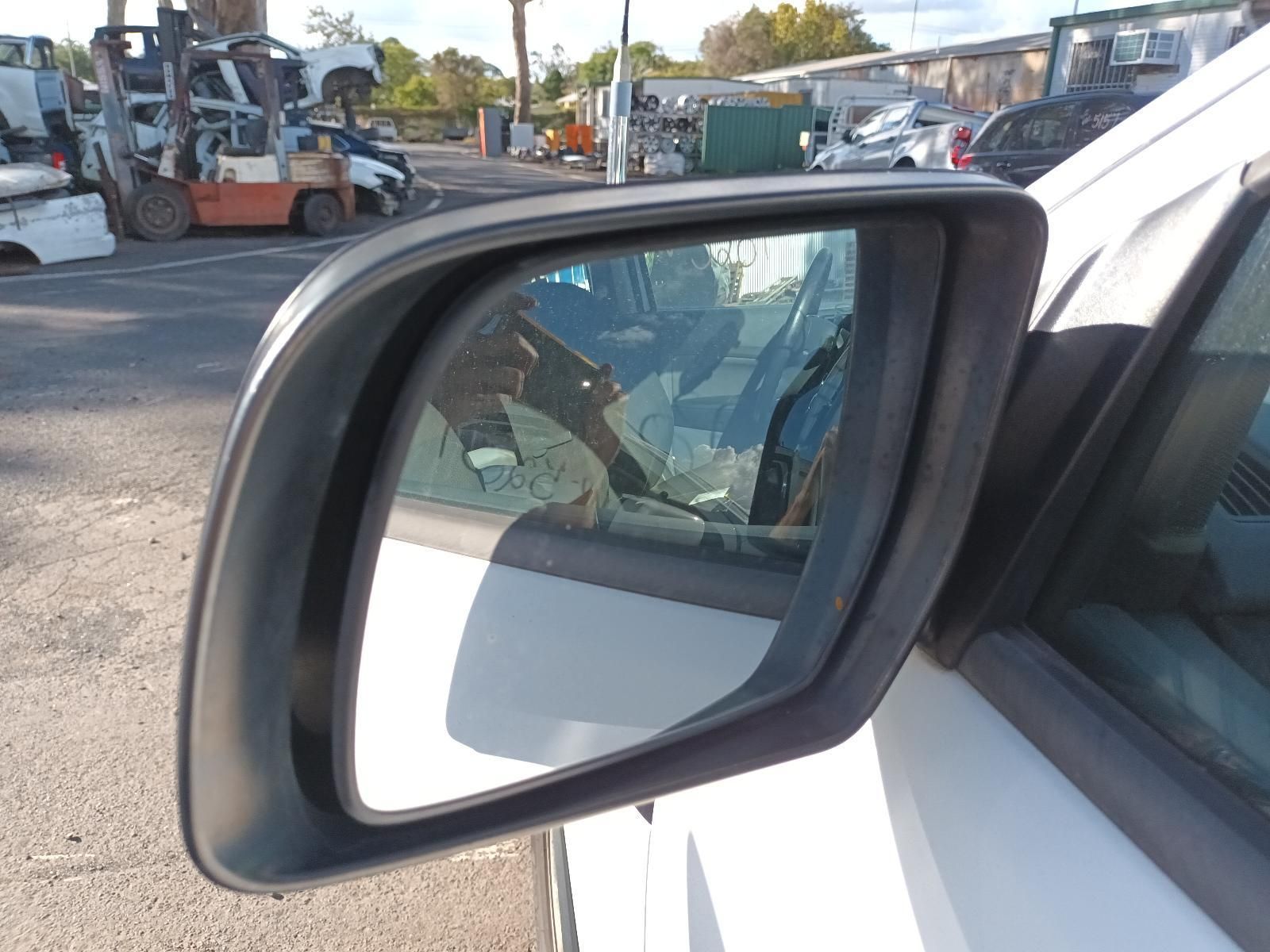 A Close Up of a Side View Mirror on a White Car — South West 4WD Wreckers in Harristown, QLD