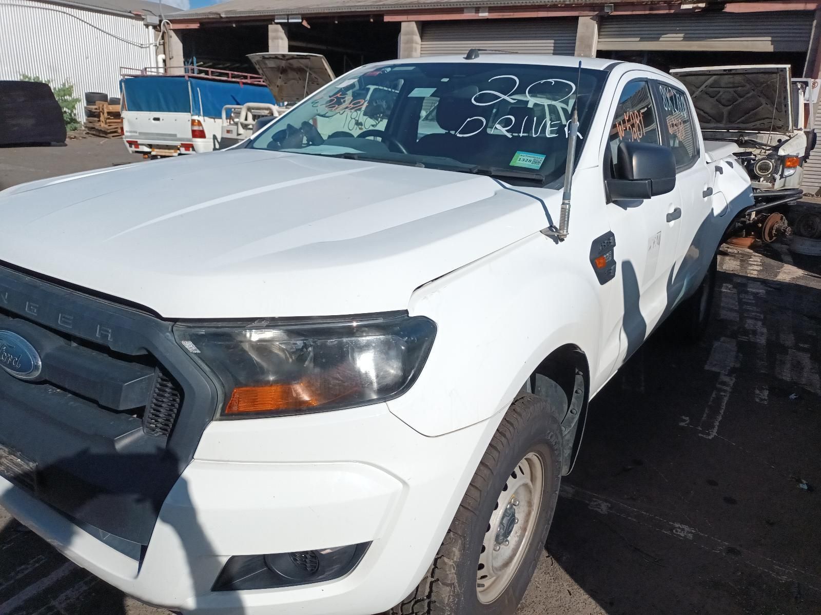 A White Ford Ranger Truck is Parked in a Parking Lot — South West 4WD Wreckers in Harristown, QLD