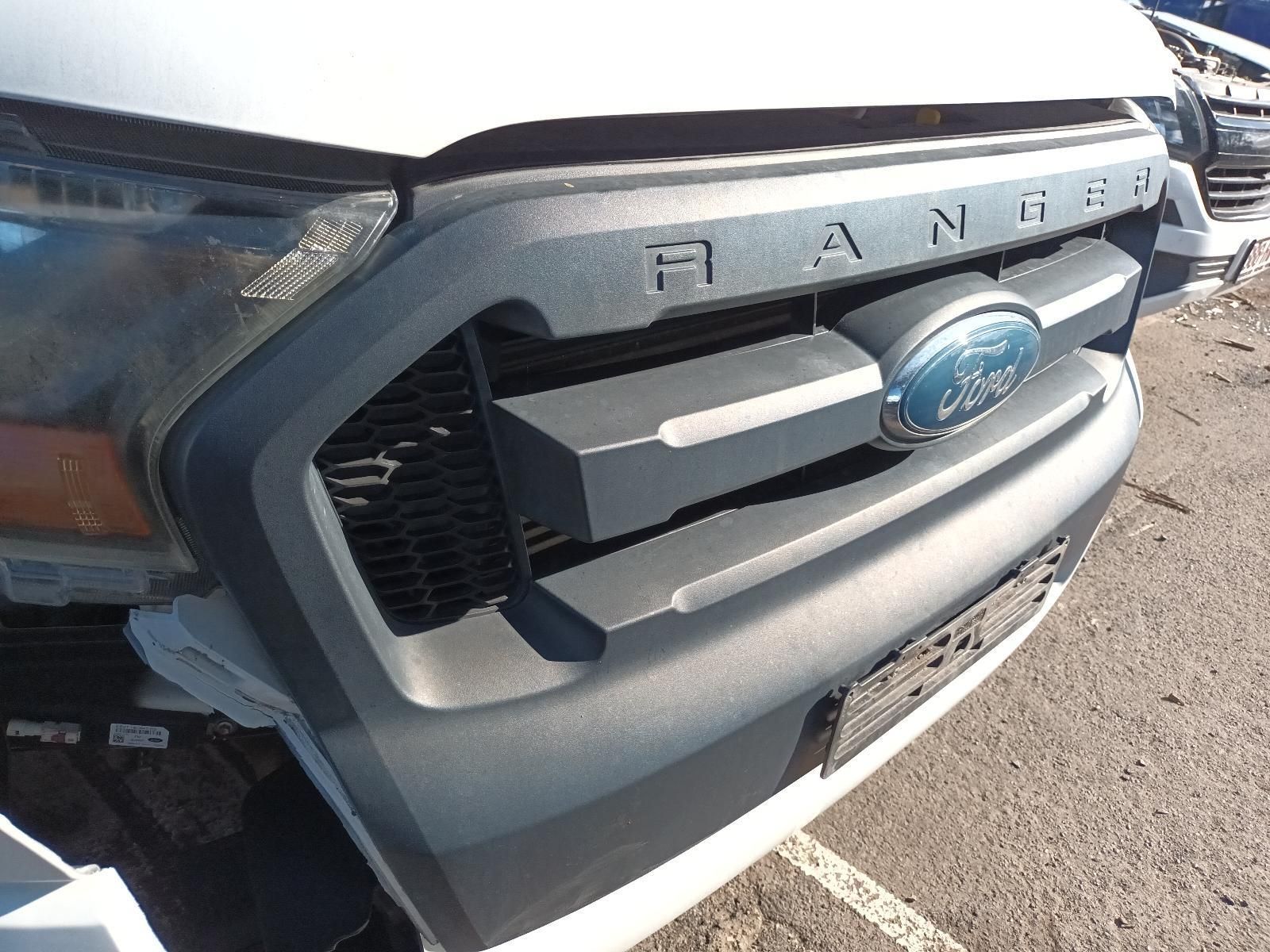A White Ford Ranger is Sitting in a Parking Lot — South West 4WD Wreckers in Harristown, QLD