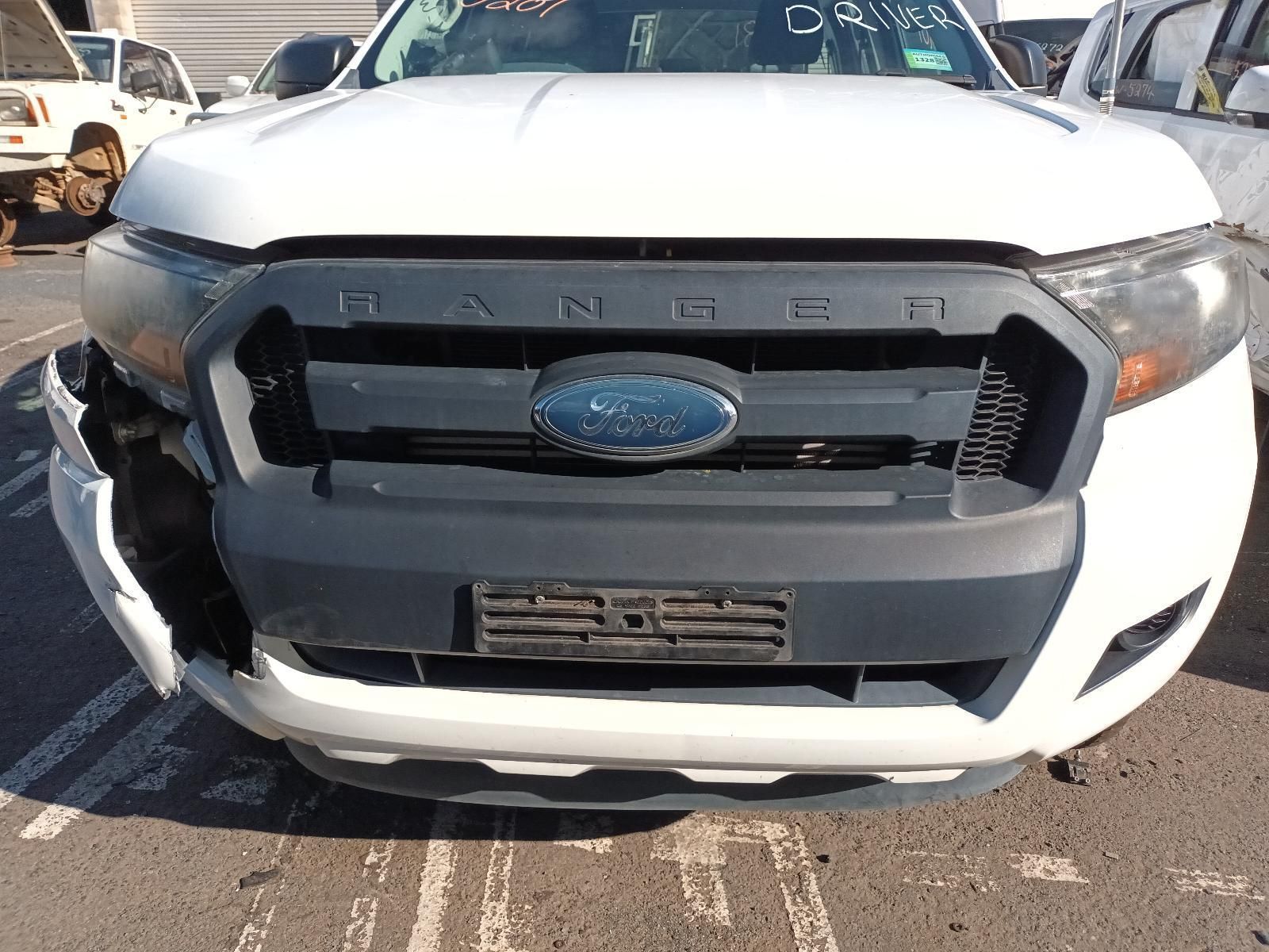 A White Ford Ranger with a Damaged Front Bumper is Parked in a Parking Lot — South West 4WD Wreckers in Harristown, QLD