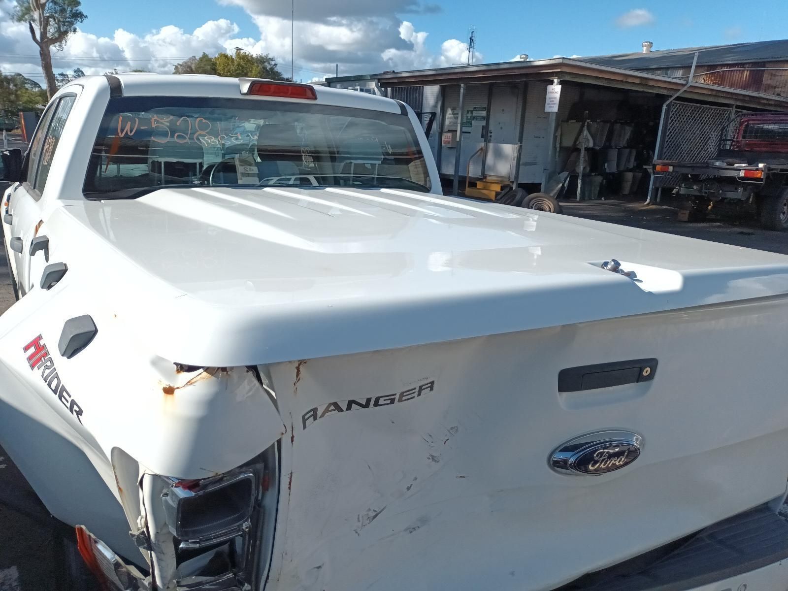 A White Truck with a White Bed Cover is Parked in a Parking Lot — South West 4WD Wreckers in Harristown, QLD