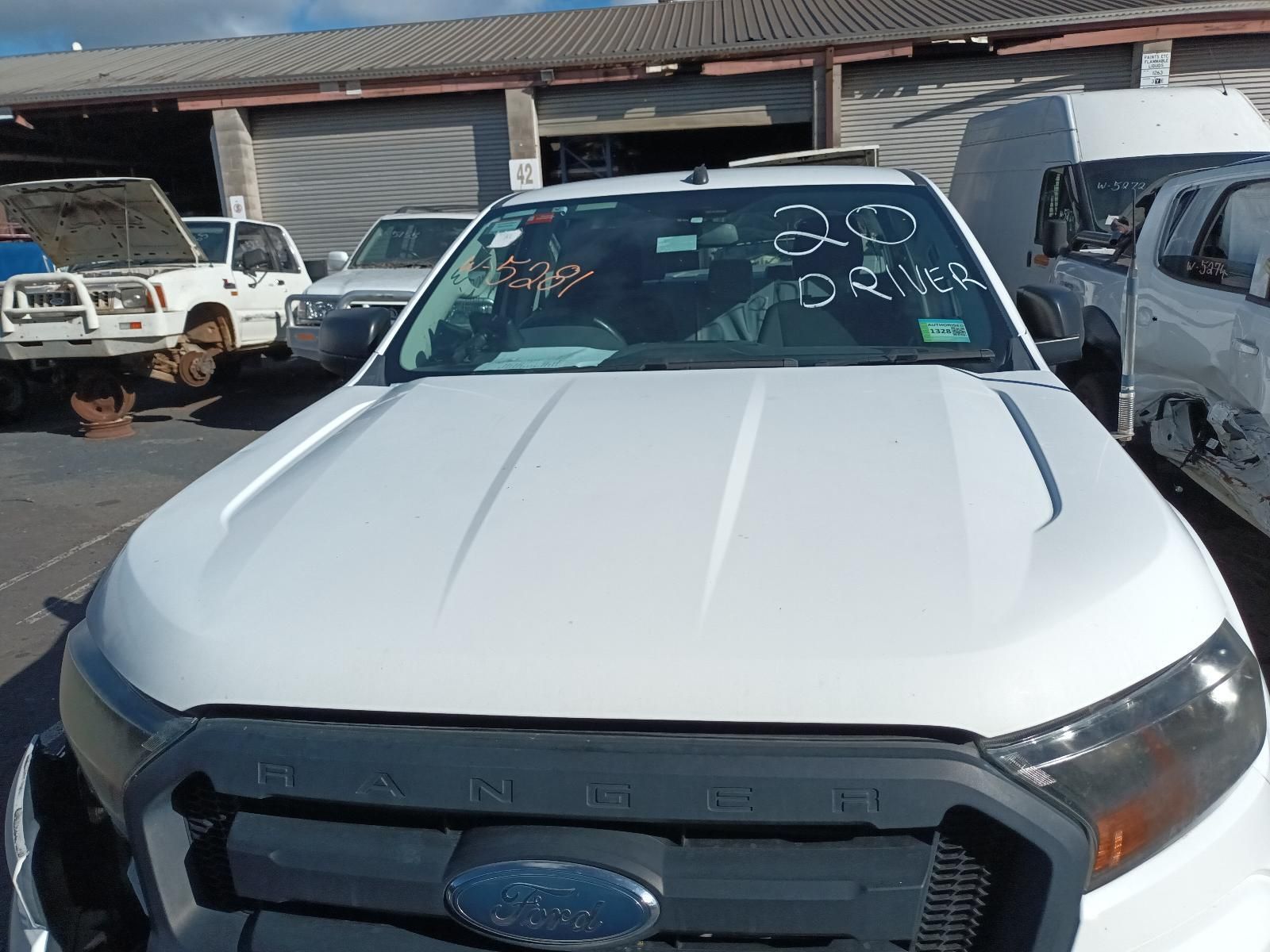 A White Ford Truck is Parked in a Parking Lot — South West 4WD Wreckers in Harristown, QLD