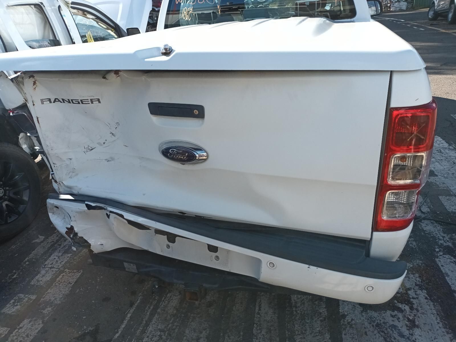 The Back End of a White Ford Ranger Pickup Truck is Damaged — South West 4WD Wreckers in Harristown, QLD