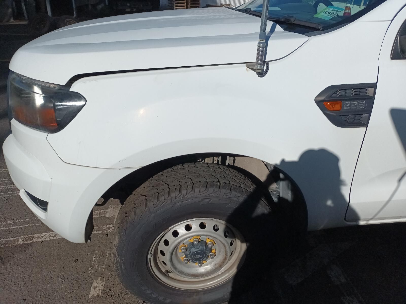 A White Truck with a Broken Fender is Parked in a Parking Lot — South West 4WD Wreckers in Harristown, QLD