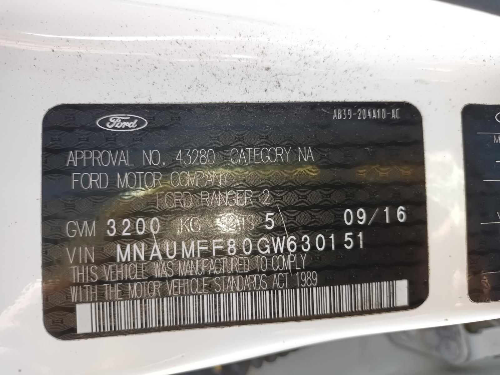 A White Ford Car with a License Plate — South West 4WD Wreckers in Harristown, QLD