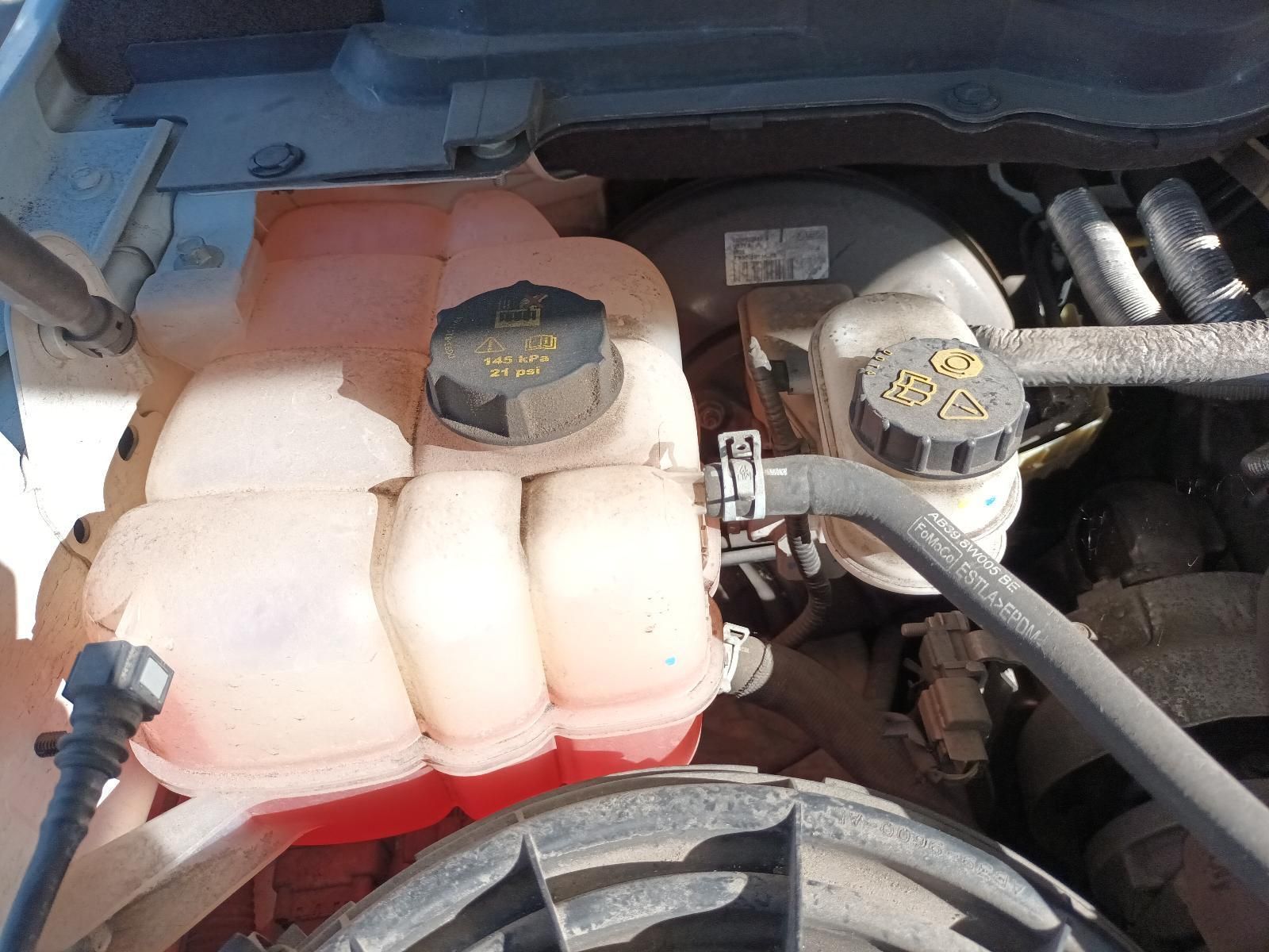 A Close Up of the Engine of a Car with a Red Water Tank — South West 4WD Wreckers in Harristown, QLD