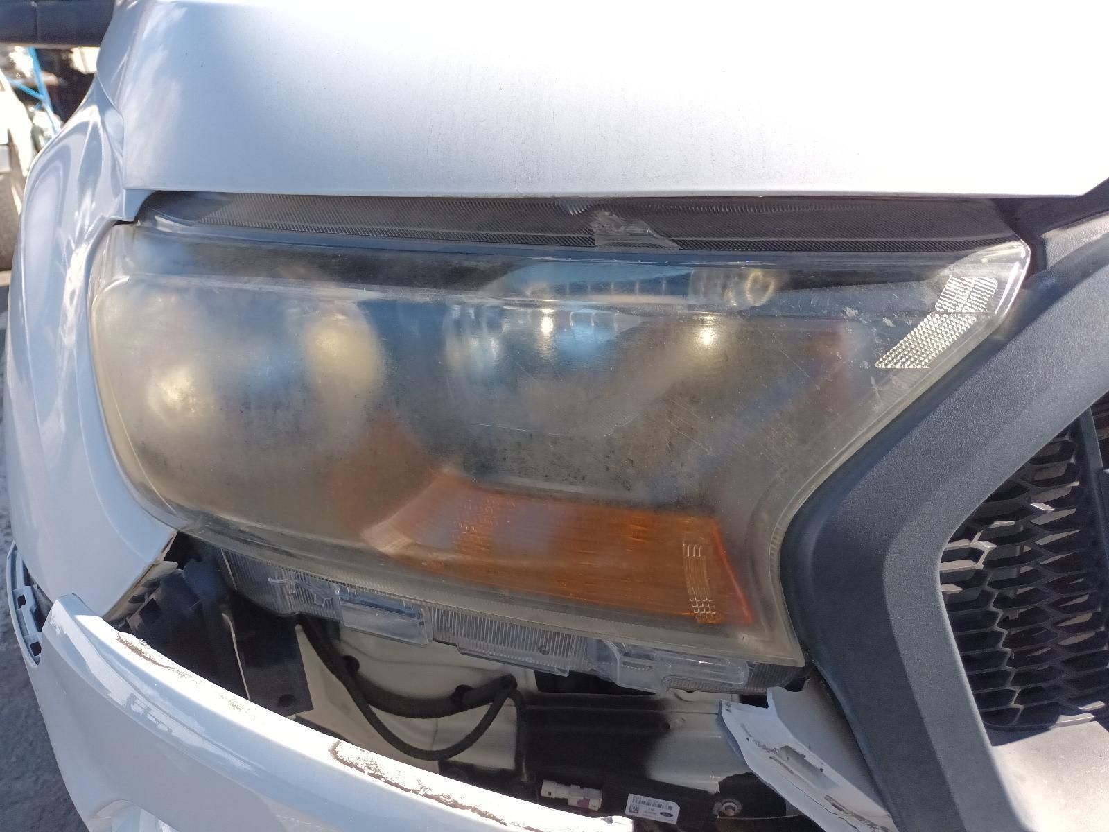 A Close Up of a Car's Headlight with a Broken Bumper — South West 4WD Wreckers in Harristown, QLD