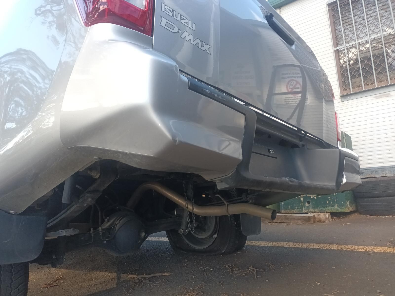 A Silver Car with a Damaged Bumper is Parked in a Parking Lot — South West 4WD Wreckers in Harristown, QLD