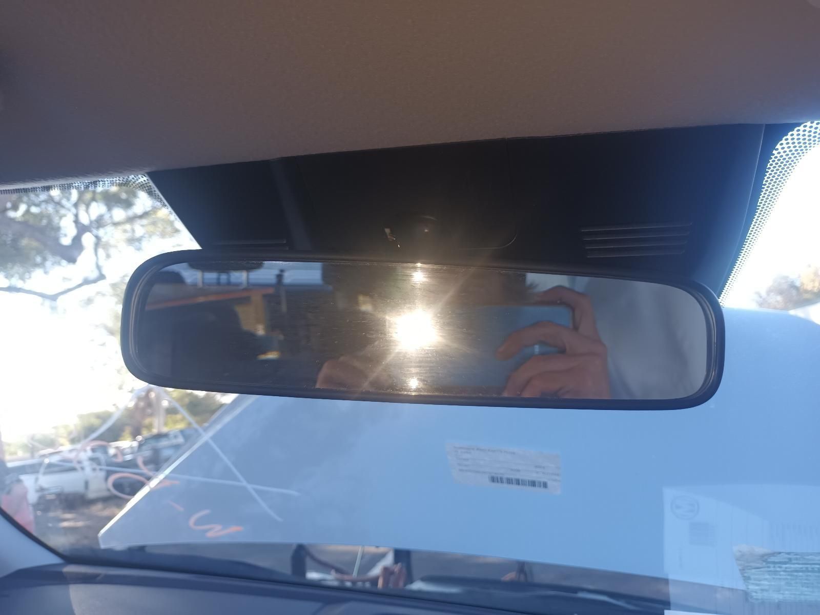 A Person is Taking a Picture of Themselves in the Rear View Mirror of a Car — South West 4WD Wreckers in Harristown, QLD