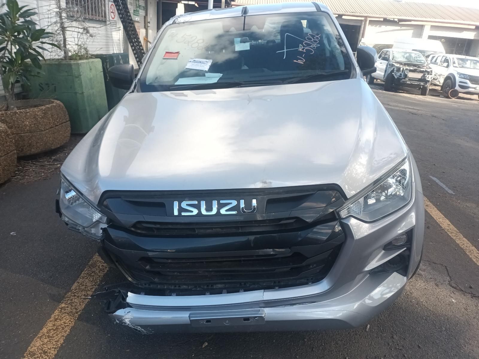 A Silver Isuzu Truck is Parked in a Parking Lot — South West 4WD Wreckers in Harristown, QLD