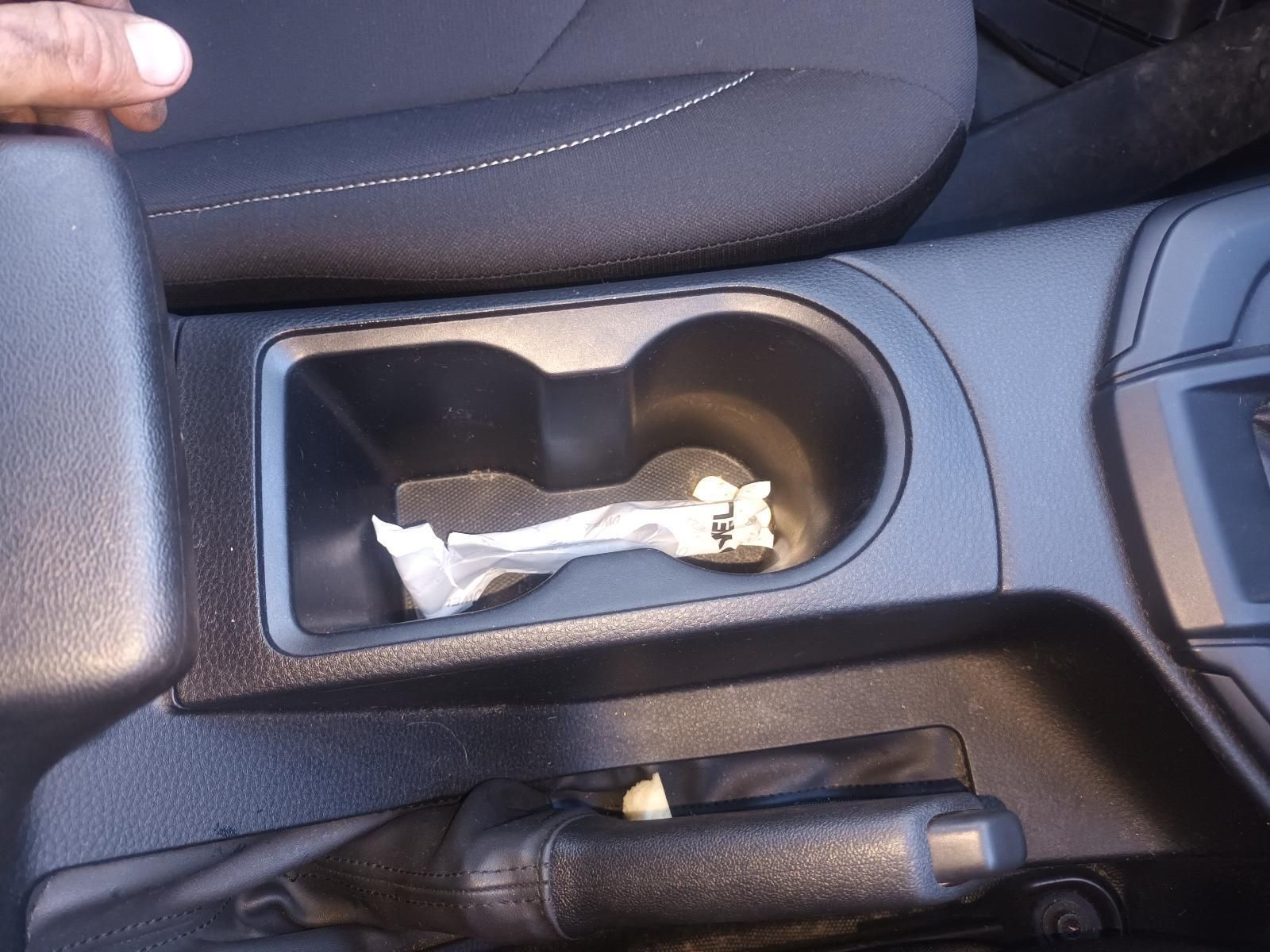 A Person is Holding a Cup Holder in a Car — South West 4WD Wreckers in Harristown, QLD