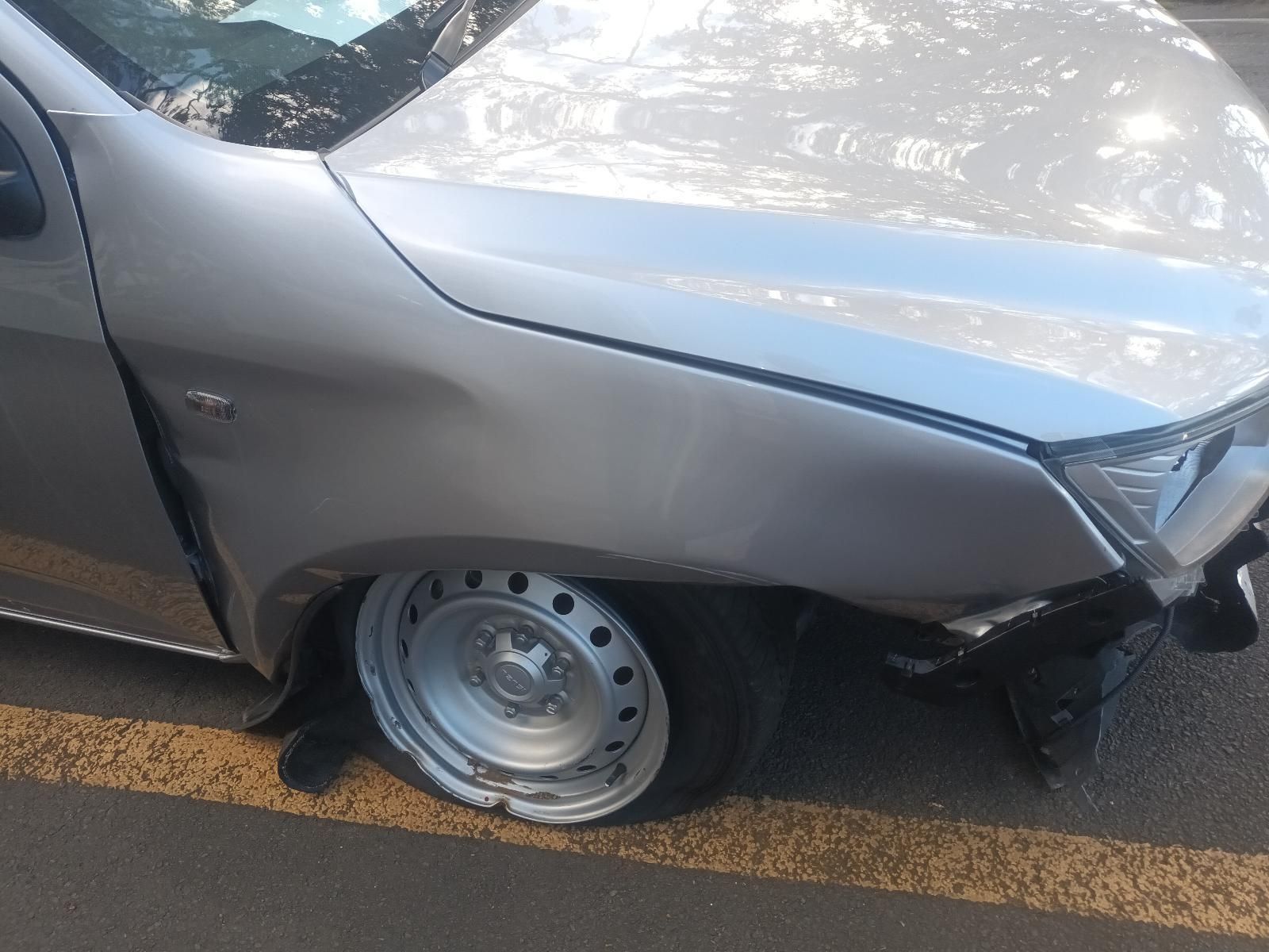 A Silver Car with a Flat Tire is Parked on the Side of the Road — South West 4WD Wreckers in Harristown, QLD