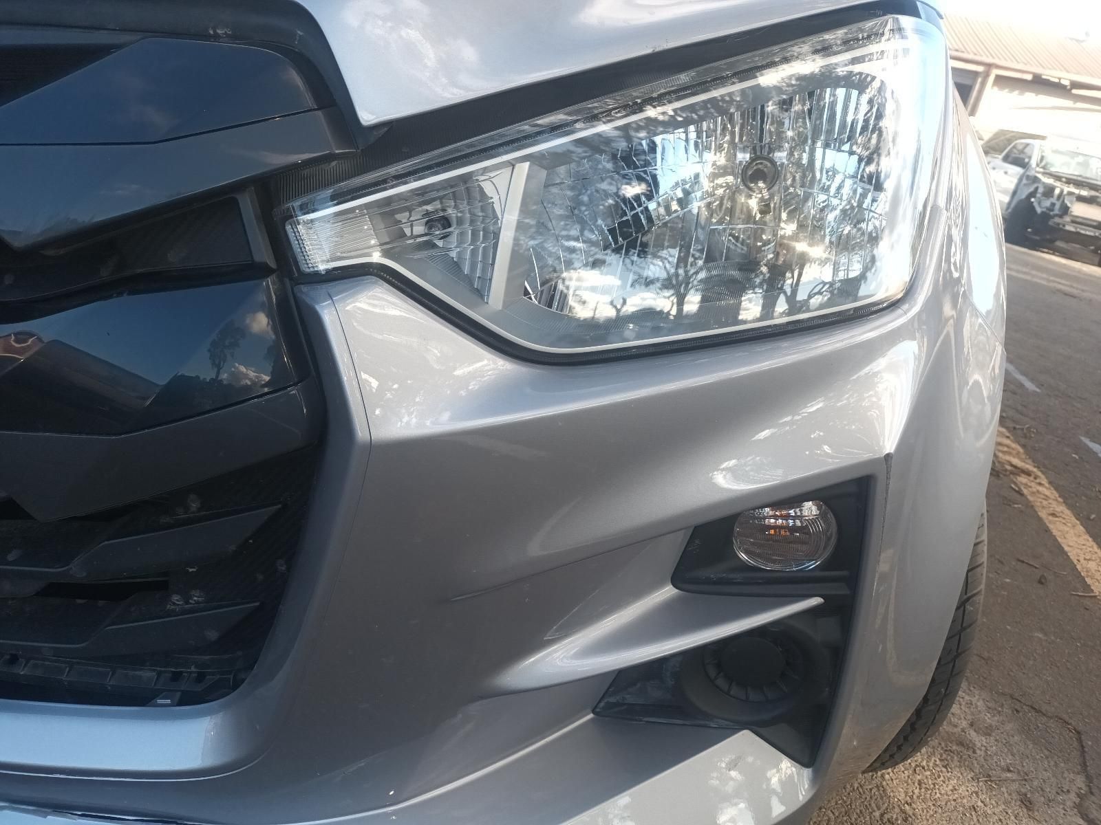 A Close Up of a Silver Car 's Headlight in a Parking Lot — South West 4WD Wreckers in Harristown, QLD