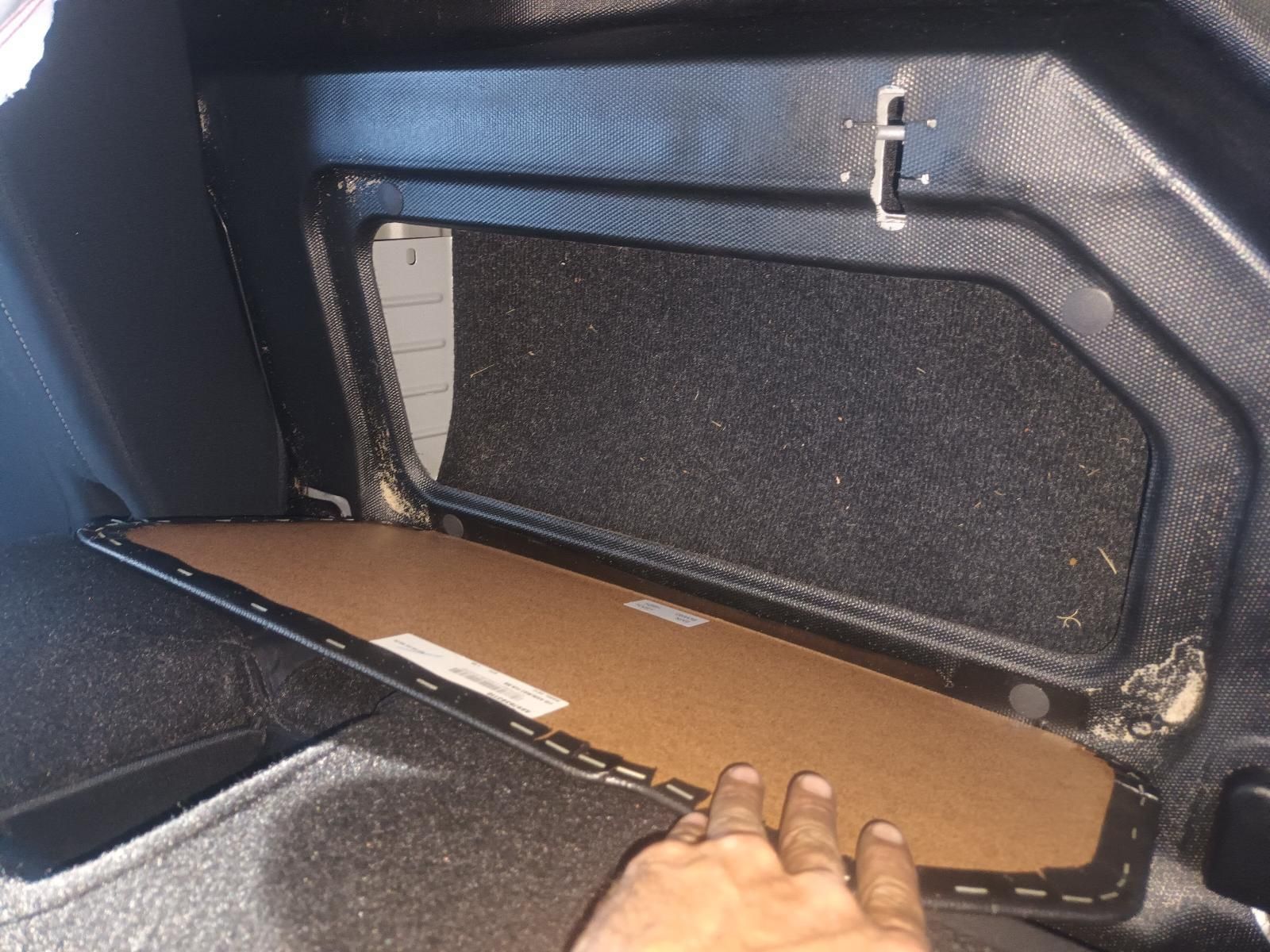A Person is Holding a Piece of Cardboard in a Car Trunk — South West 4WD Wreckers in Harristown, QLD