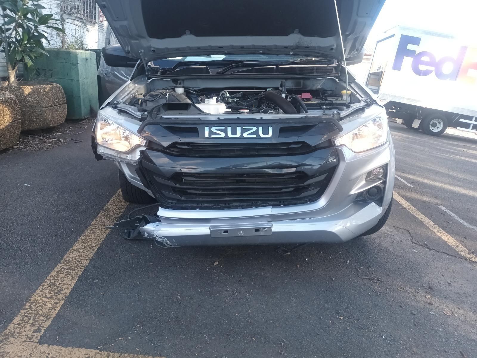 A Gray Isuzu Truck with the Hood Up is Parked in a Parking Lot — South West 4WD Wreckers in Harristown, QLD