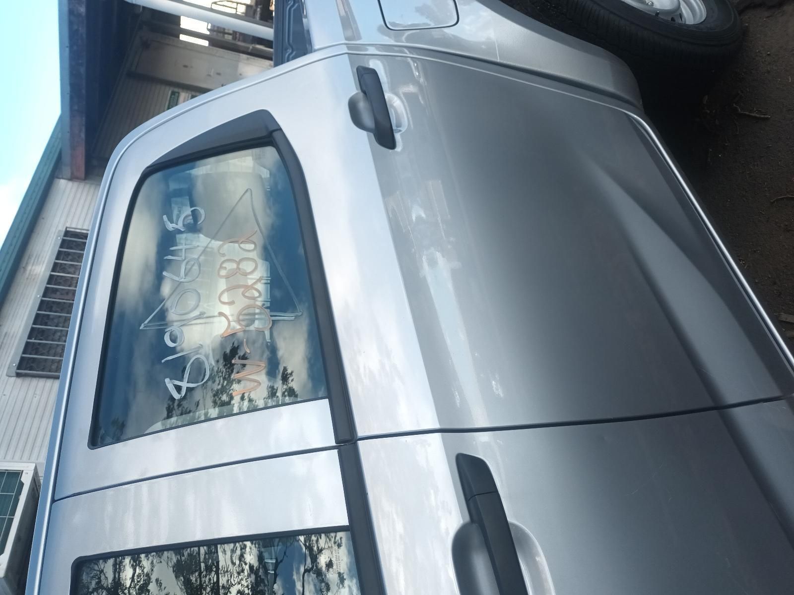 A Silver Truck is Parked in Front of a Building — South West 4WD Wreckers in Harristown, QLD