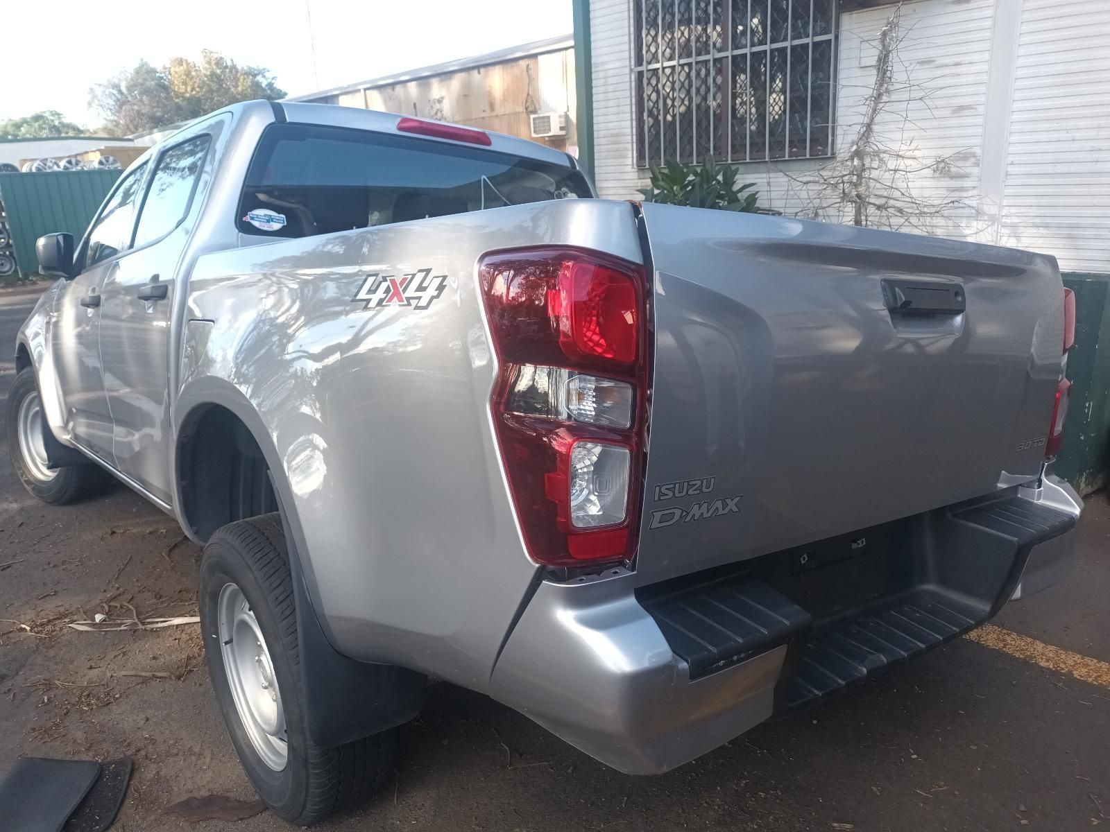 A Silver Pickup Truck is Parked in Front of a Building — South West 4WD Wreckers in Harristown, QLD