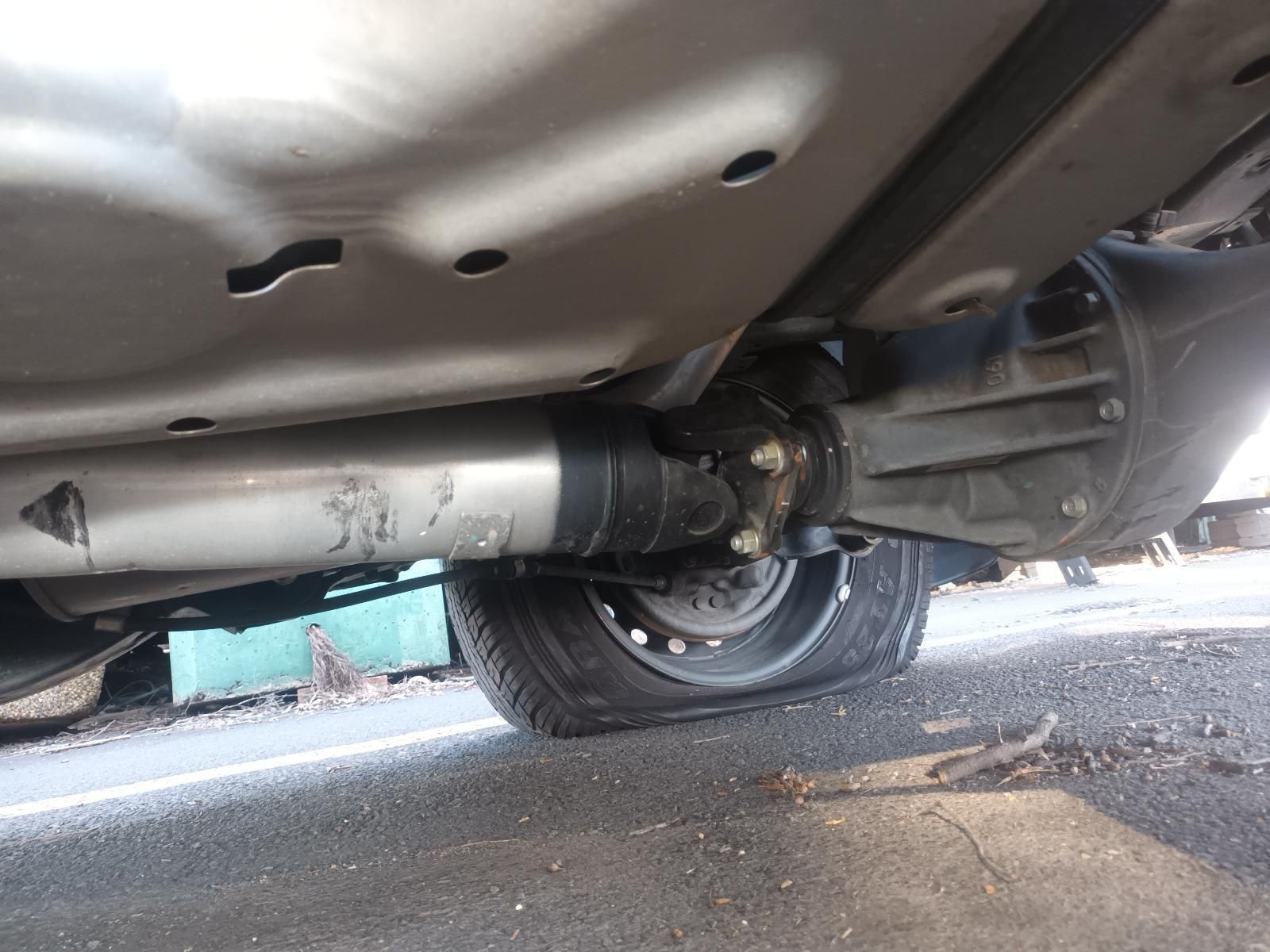 A Close Up of the Underside of a Car with a Tire on the Ground — South West 4WD Wreckers in Harristown, QLD