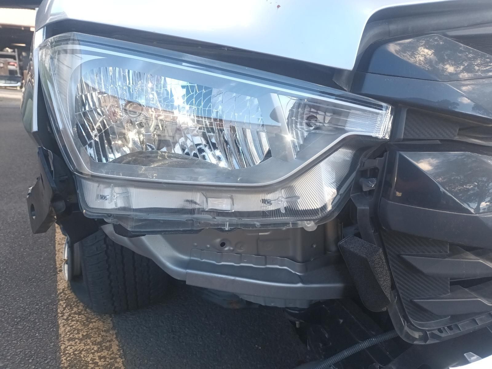 A Car with a Broken Headlight is Parked on the Side of the Road — South West 4WD Wreckers in Harristown, QLD