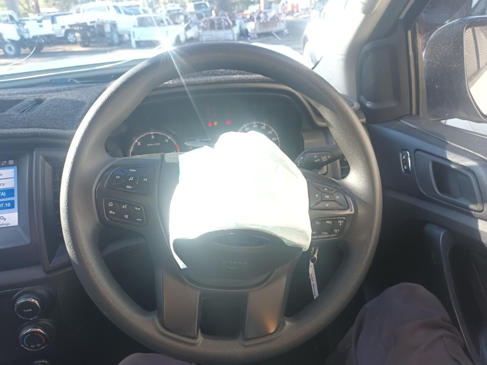 A Person is Sitting in a Car with an Airbag on the Steering Wheel — South West 4WD Wreckers in Harristown, QLD
