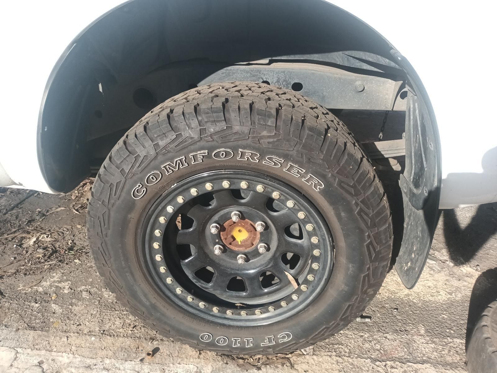 A close up of a tire on a white truck