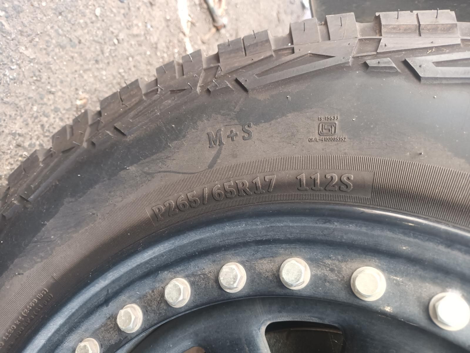 A Close Up of a Tire with a Metal Rim on a Concrete Surface — South West 4WD Wreckers in Harristown, QLD